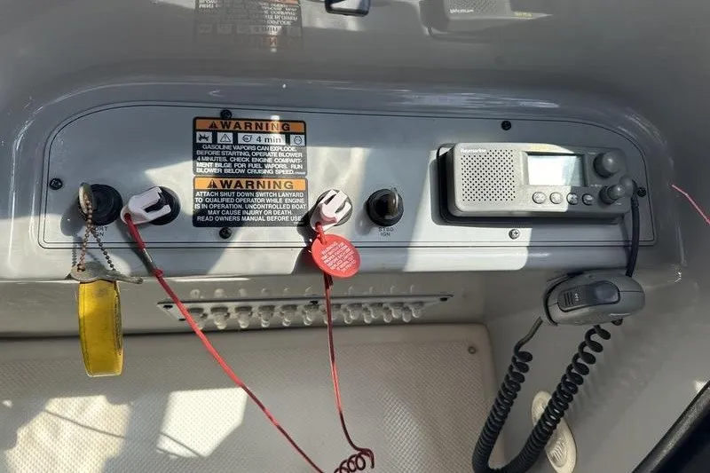 Slide: The Image of Control panel of a 2004 Bayliner 3055 Ciera Sunbridge with warning labels and radio equipment. - 24