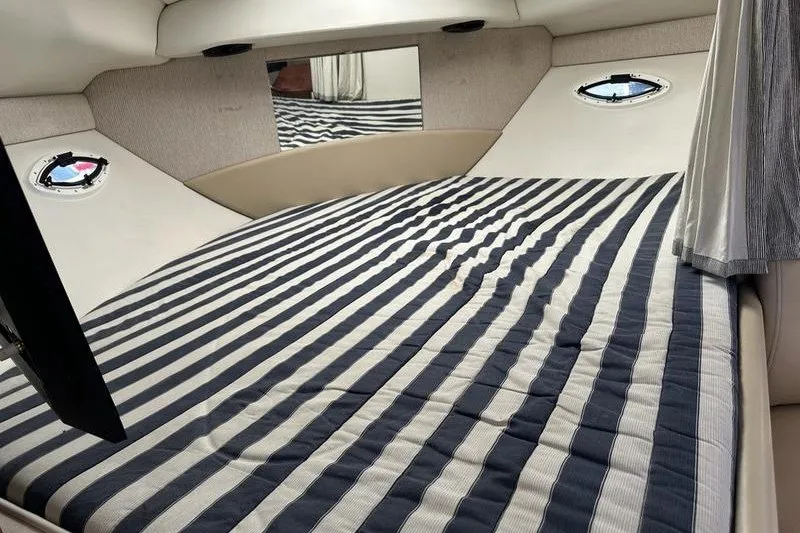 Slide: The Image of Interior cabin of 2004 Bayliner 3055 Ciera Sunbridge with striped bedding. - 31
