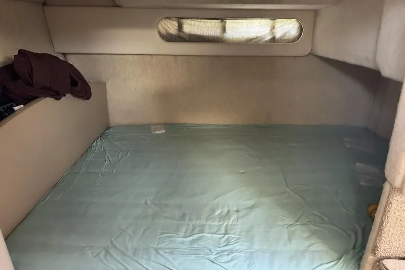 Slide: The Image of 2004 Bayliner 3055 Ciera Sunbridge cabin interior with bed and window. - 34