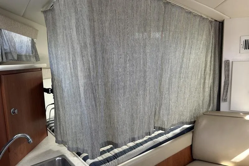 Slide: The Image of Interior of 2004 Bayliner 3055 Ciera Sunbridge with curtain and seating area. - 35