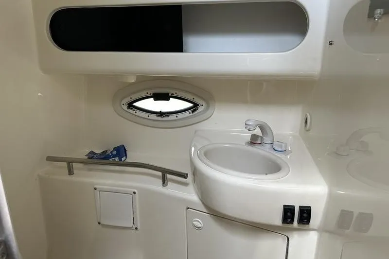 Slide: The Image of 2004 Bayliner 3055 Ciera Sunbridge bathroom with sink and porthole window. - 25