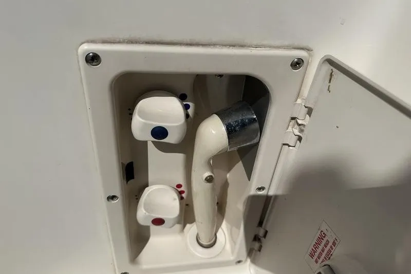 Slide: The Image of 2004 Bayliner 3055 Ciera Sunbridge shower controls with hot and cold knobs. - 43