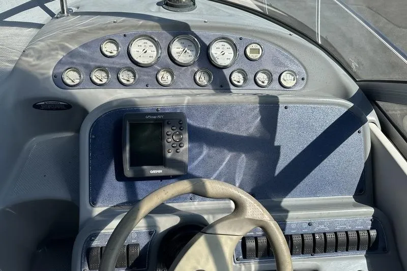 Slide: The Image of 2004 Bayliner 3055 Ciera Sunbridge dashboard with gauges and Garmin GPS device. - 22