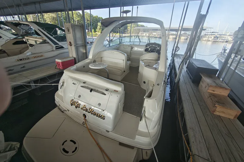 Slide: The Image of 2002 Sea Ray Sundancer 280 docked in marina, featuring spacious cockpit and helm. - 5