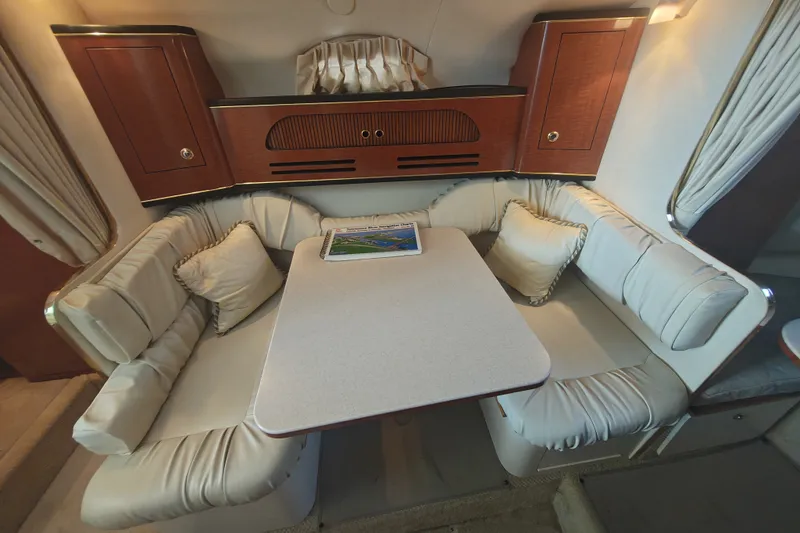 Slide: The Image of Interior of 2002 Sea Ray Sundancer 280 with cozy seating and elegant wood cabinetry. - 14