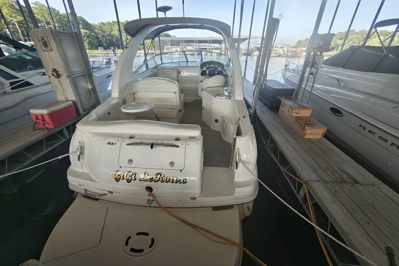 Slide: The Image of 2002 Sea Ray Sundancer 280 docked, rear view showing seating and helm. - 4