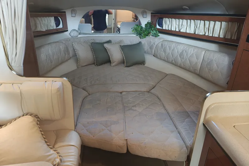 Slide: The Image of Interior of 2002 Sea Ray Sundancer 280 with cozy seating and cushions. - 10