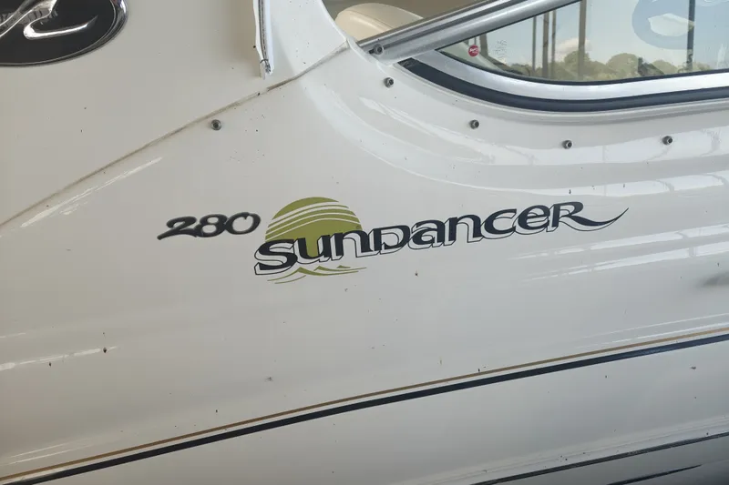 Slide: The Image of 2002 Sea Ray Sundancer 280 boat exterior with model name and logo. - 2