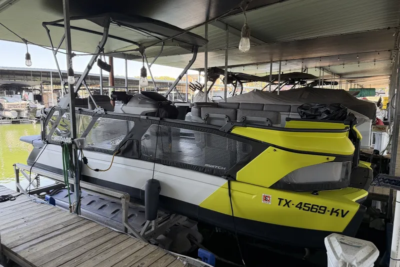 The Image of 2024 Sea-Doo Switch Cruise 21 docked at marina, featuring vibrant yellow accents. - 1