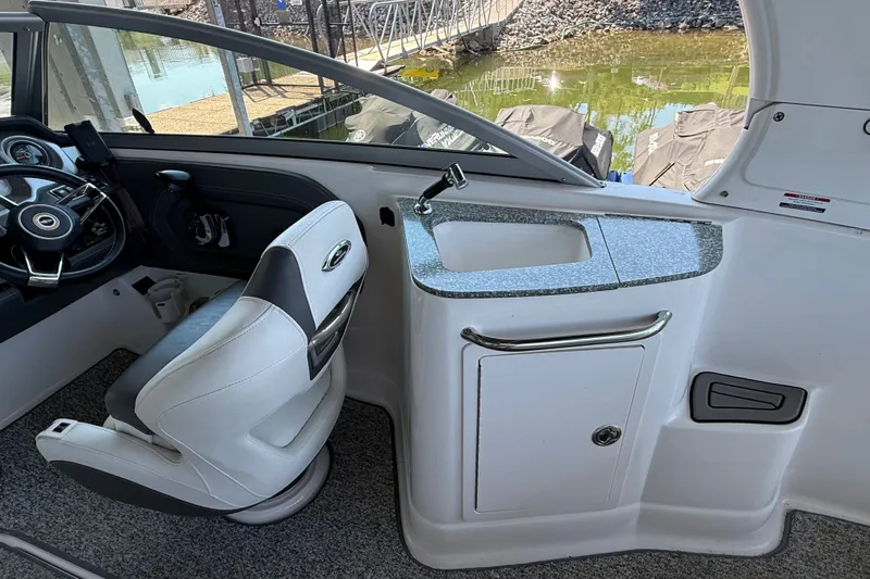 Slide: The Image of Interior of 2014 Chaparral 224 Sunesta boat with helm and sink area. - 10