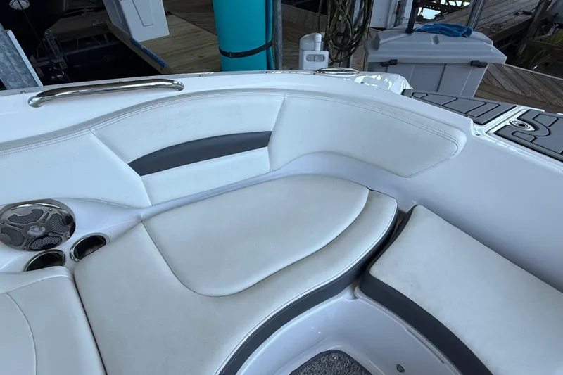 Slide: The Image of 2014 Chaparral 224 Sunesta boat interior seating with cup holders and speaker. - 26