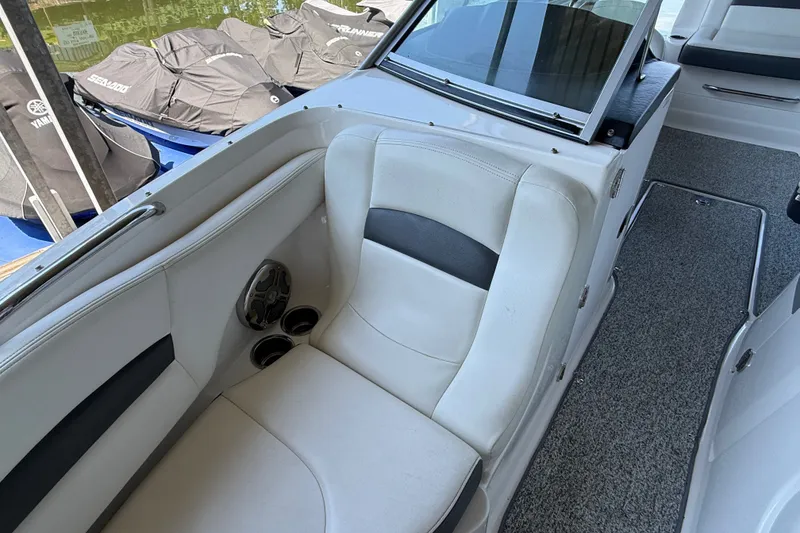 Slide: The Image of Interior of 2014 Chaparral 224 Sunesta boat with white seating and carpeted floor. - 27
