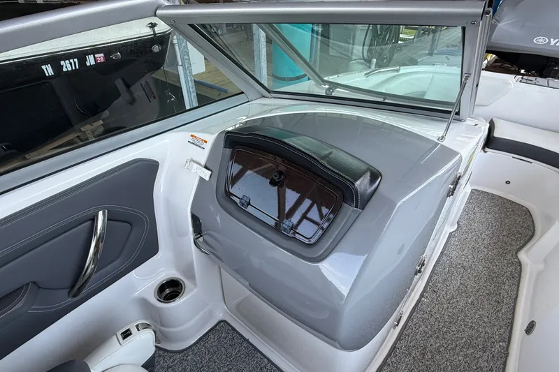Slide: The Image of Interior view of a 2014 Chaparral 224 Sunesta boat, featuring sleek design and seating area. - 16