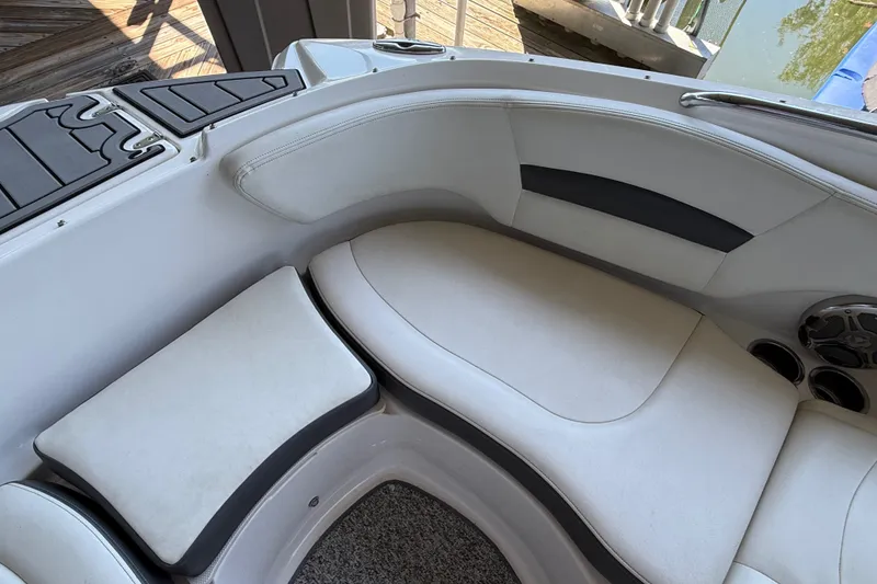Slide: The Image of 2014 Chaparral 224 Sunesta boat interior with cushioned seating and cup holders. - 25