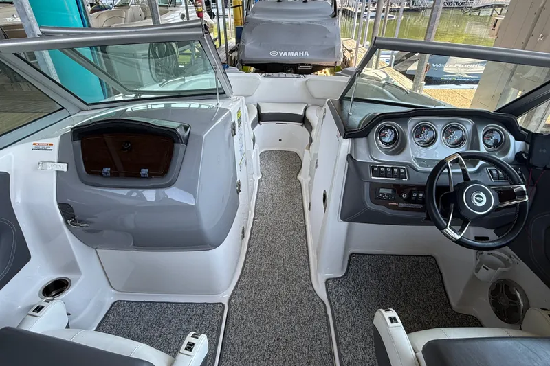 Slide: The Image of 2014 Chaparral 224 Sunesta boat interior with steering wheel and dashboard controls. - 14
