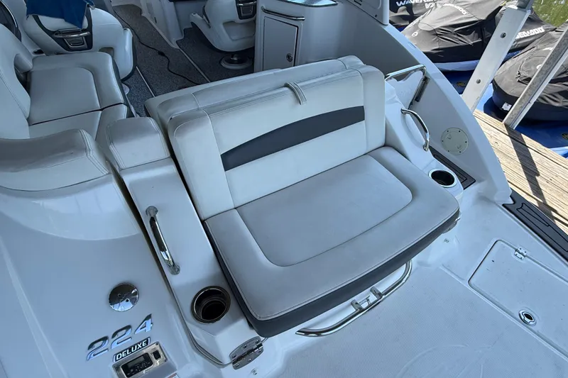 Slide: The Image of 2014 Chaparral 224 Sunesta boat interior with white seating and cup holders. - 8
