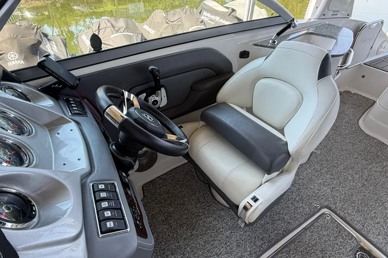 Slide: The Image of Interior of 2014 Chaparral 224 Sunesta boat with steering wheel and captain's seat. - 19
