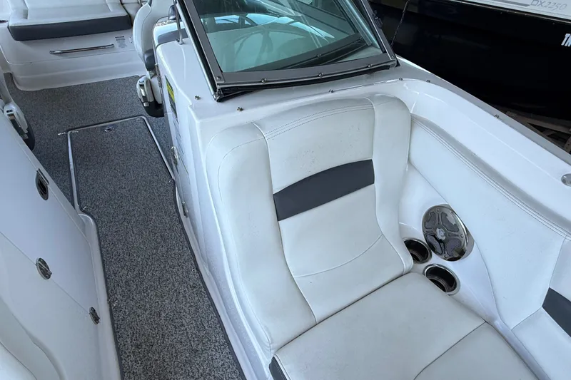 Slide: The Image of 2014 Chaparral 224 Sunesta boat interior with white seating and speaker system. - 28