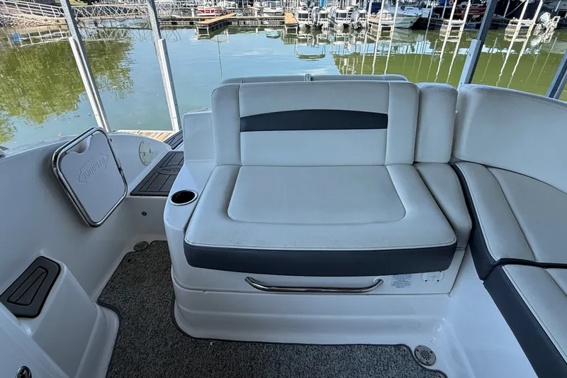 Slide: The Image of Interior seating of 2014 Chaparral 224 Sunesta boat, docked by the water. - 11