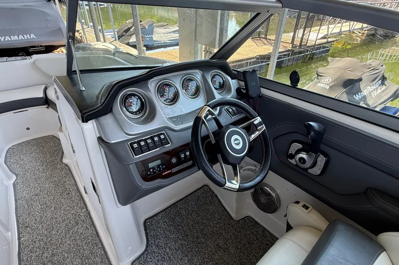 Slide: The Image of Interior view of 2014 Chaparral 224 Sunesta boat dashboard and steering wheel. - 17