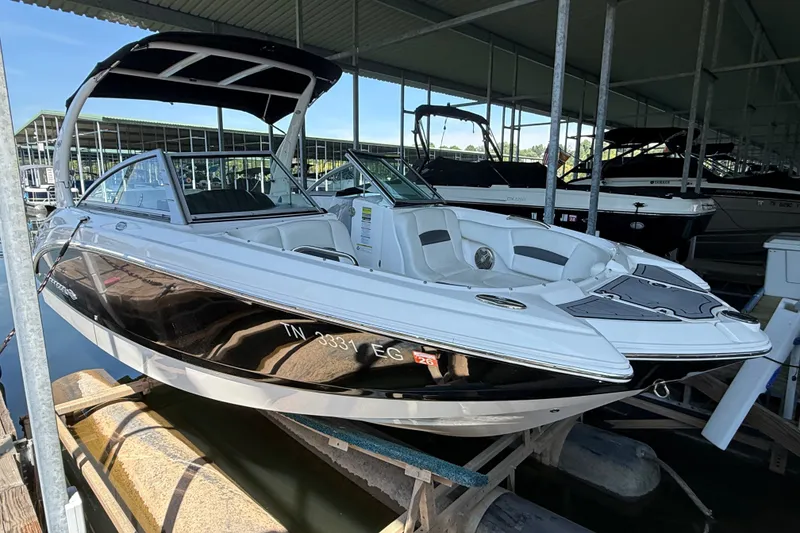 The Image of 2014 Chaparral 224 Sunesta boat docked under a covered marina. - 0