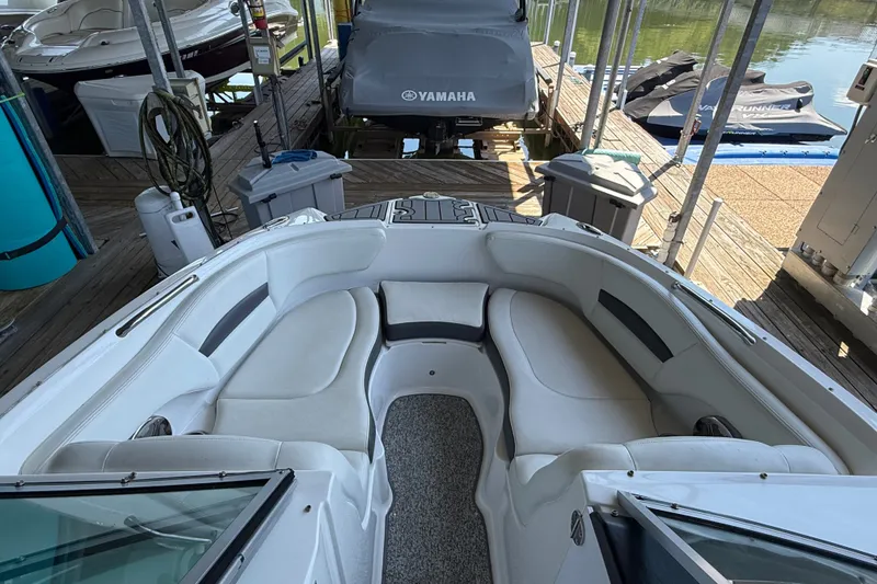 Slide: The Image of 2014 Chaparral 224 Sunesta boat with spacious seating at a dock. - 21