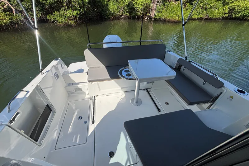 Slide: The Image of 2025 Beneteau Antares 8 boat interior with seating and table on calm water. - 20