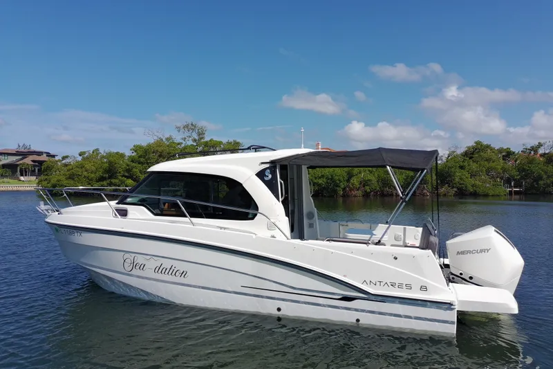 Slide: The Image of 2025 Beneteau Antares 8 boat on calm water, featuring sleek design and Mercury engine. - 13