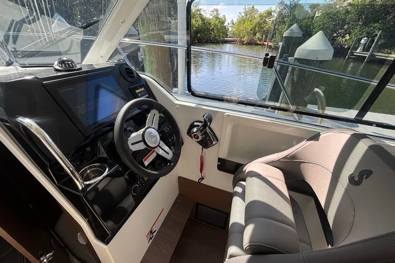 Slide: The Image of Interior cockpit of 2025 Beneteau Antares 8, featuring steering wheel and navigation controls. - 17