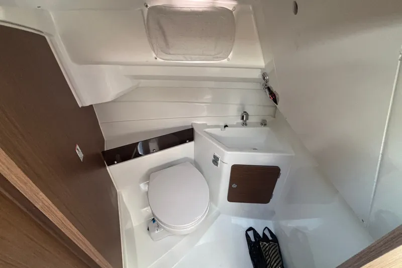 Slide: The Image of 2025 Beneteau Antares 8 boat bathroom with sink, toilet, and storage cabinet. - 18