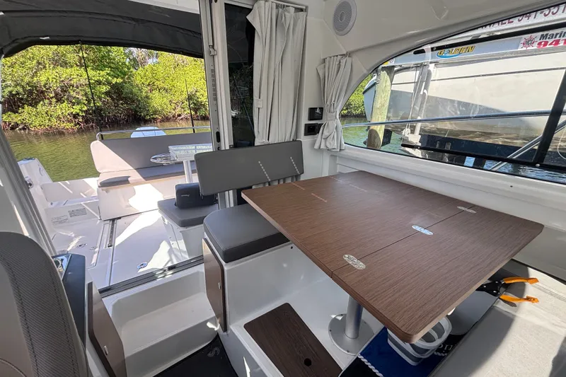 Slide: The Image of Interior of 2025 Beneteau Antares 8 boat with dining table and seating area. - 32