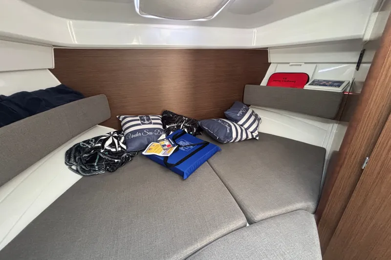 Slide: The Image of 2025 Beneteau Antares 8 cabin interior with cushions and nautical decor. - 29