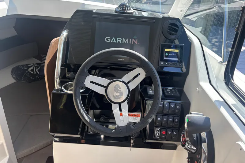 Slide: The Image of 2025 Beneteau Antares 8 cockpit with Garmin navigation system and modern controls. - 28