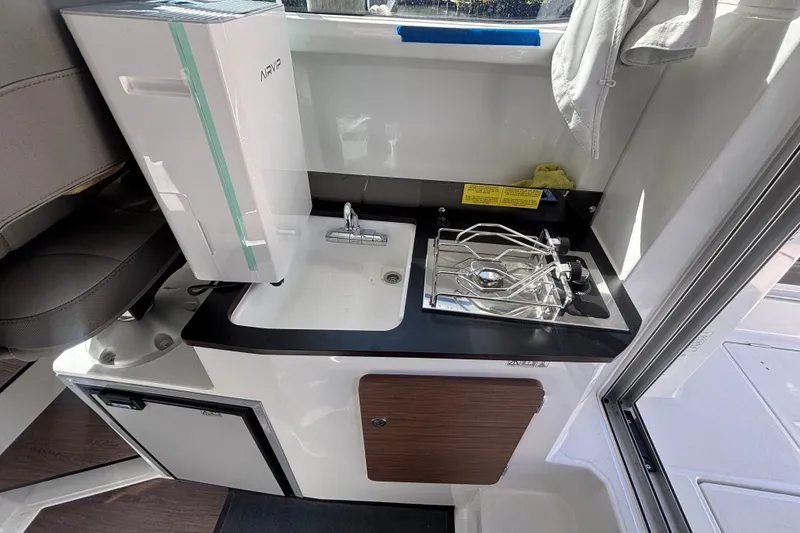 Slide: The Image of Compact kitchen area in 2025 Beneteau Antares 8 boat with sink and stove. - 16
