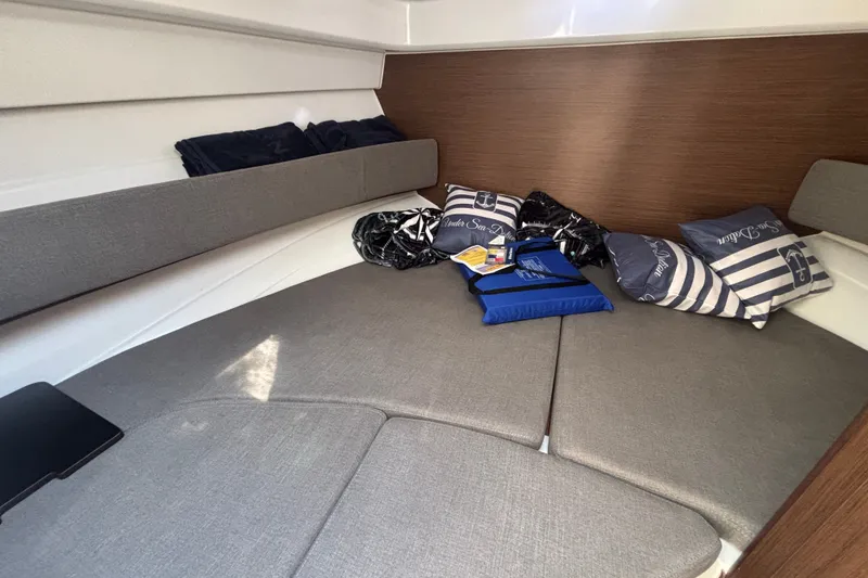Slide: The Image of Interior cabin of 2025 Beneteau Antares 8 with cushions and nautical decor. - 19