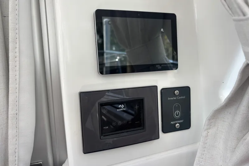 Slide: The Image of Control panel on 2025 Beneteau Antares 8 boat, featuring touchscreen and inverter control. - 21
