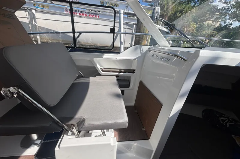 Slide: The Image of Interior of 2025 Beneteau Antares 8 boat, featuring seating and helm area. - 22