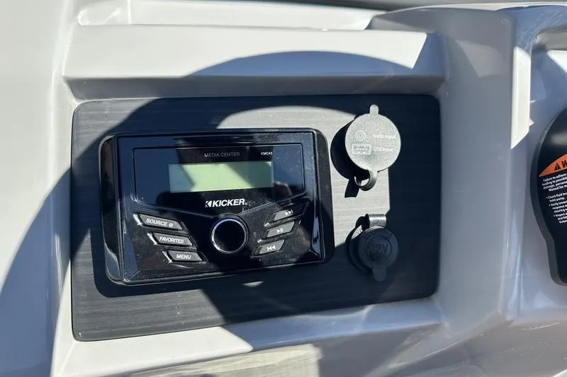Slide: The Image of Kicker media center on 2022 Bennington 23 LSR boat dashboard with USB and 12V inputs. - 22