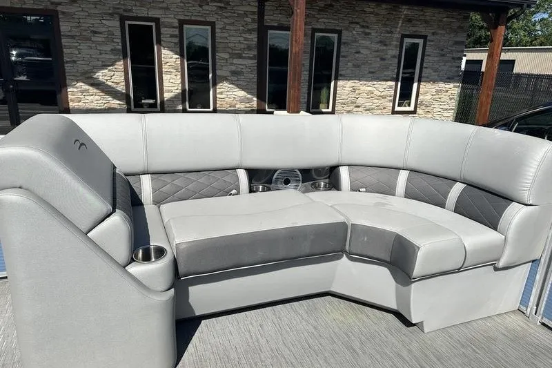 Slide: The Image of 2022 Bennington 23 LSR boat interior with gray cushioned seating and cup holders. - 18
