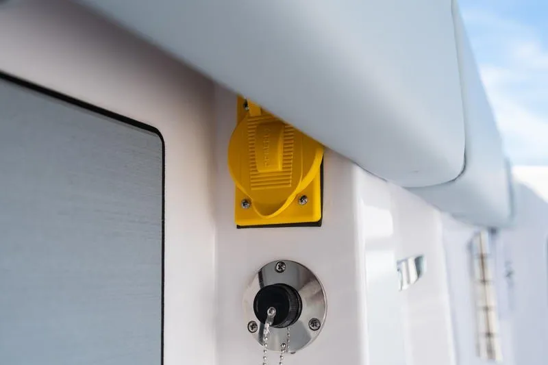 Slide: The Image of Close-up of 2027 Sportsman Open 232 Center Console boat ignition and yellow switch. - 31