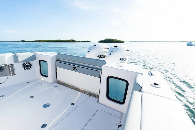 Slide: The Image of 2027 Sportsman Open 232 Center Console boat on calm water, featuring dual engines. - 3