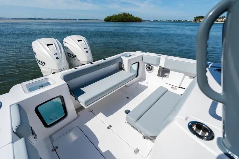 Slide: The Image of 2027 Sportsman Open 232 Center Console boat with dual engines on calm water. - 18