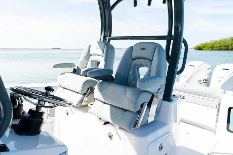 Slide: The Image of 2027 Sportsman Open 232 Center Console boat with luxurious seating and steering wheel. - 38