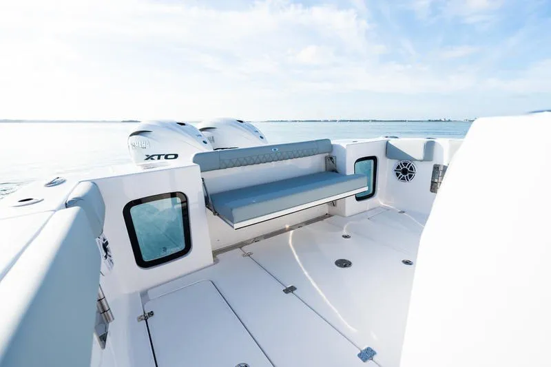 Slide: The Image of 2027 Sportsman Open 232 Center Console boat interior with seating and twin engines. - 11