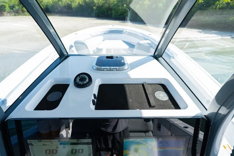 Slide: The Image of 2027 Sportsman Open 232 Center Console boat interior with navigation equipment and dashboard. - 30