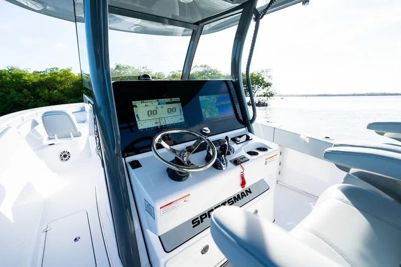 Slide: The Image of 2027 Sportsman Open 232 Center Console boat interior with steering wheel and digital displays. - 28