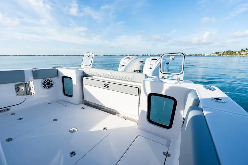 Slide: The Image of 2027 Sportsman Open 232 Center Console boat on calm blue water. - 5