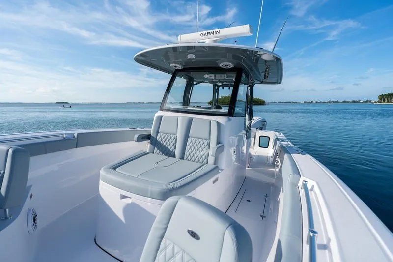 Slide: The Image of 2027 Sportsman Open 232 Center Console boat on calm water, featuring sleek design and modern amenities. - 8