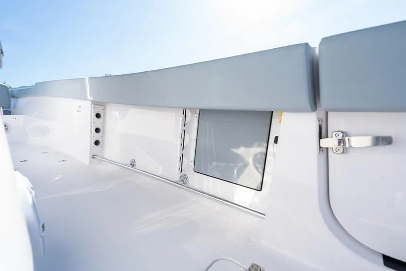 Slide: The Image of 2027 Sportsman Open 232 Center Console interior with sleek white finish and storage compartment. - 15