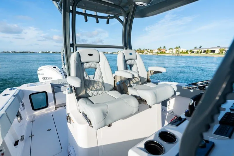 Slide: The Image of 2027 Sportsman Open 232 Center Console boat interior with luxurious seating and ocean view. - 39